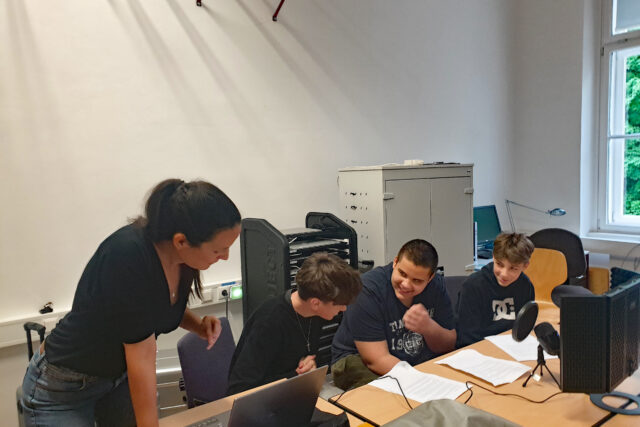 Jugendliche vor einem Aufnahmegerät